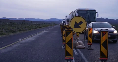 Traffic queue at roadworks with hills in background Stock Footage 277389972