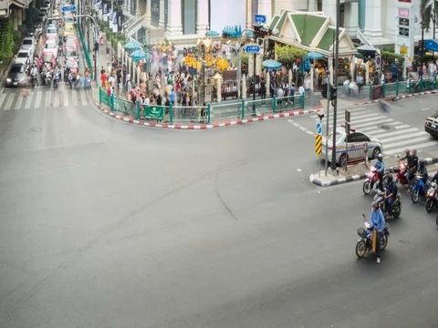Traffic on Ratchadamri Road intersection and Erawan Shrine, Bangkok, Thailand, Stock Footage