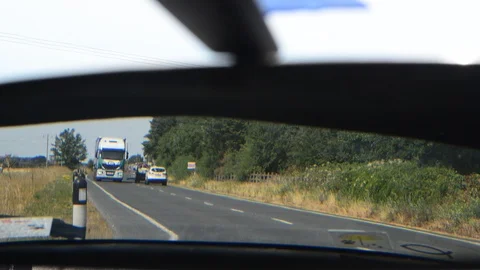 Traffic reflected in vehicle rear view mirror united kingdom Stock Footage 92845507