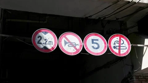 Traffic restriction signs under building overpass Stock Footage 345417391