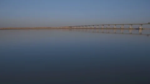 Traffic on the road bridge. Light trucks and trucks moving on a concrete bridge. Stock Footage 106123768