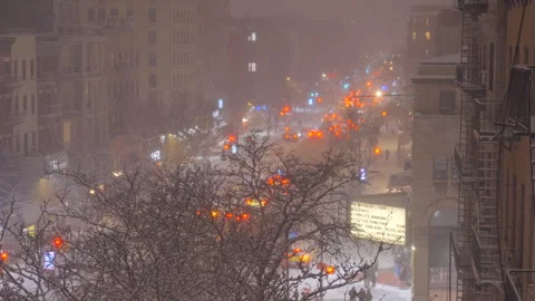 Traffic at road intersection during Snow storm at East Village in New York City. Видео 302194098