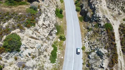 Traffic road surrounded with rocks on the hill and cars passing . Aerial view Видео 139934346