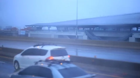 Traffic on the road while raining Stock Footage 94440024