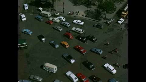 Traffic rotating  the Arch of Triumph, from overhead atop the arch, Paris, 1970 Stock Footage 85853695