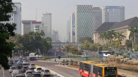 Traffic at roundabout with skyline in Jakarta Java Indonesia Stock-Footage 81913082