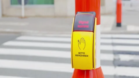 Traffic rules. A pedestrian presses a traffic light button to cross the road. A Stock Footage 308290903