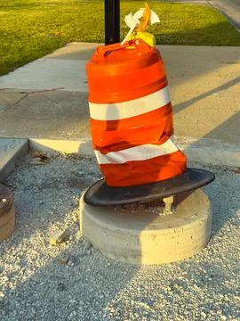 Traffic safety cone placed at construction site on a clear day with grass i.. Stock Photos