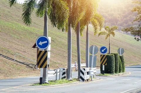 A traffic sign indicates a left-hand intersection ahead. Stock Photos