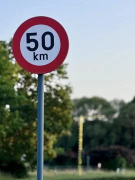 Traffic sign indicating the maximum speed of 50 km per hour Stock Photos