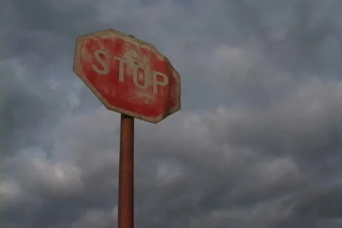Traffic sign over cloudy sky in time-lapse loop Stock Footage 346546