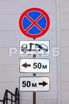 Traffic sign prohibiting parking. Evacuation on tow truck Stock Photos