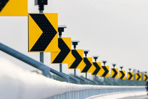 Traffic sign with solar cell panel power on white sky background. Electric po 库存照片