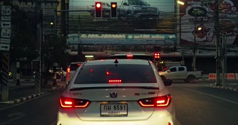Traffic signal change urban intersection vehicle cityscape rear view commuting Stock Footage 334635860