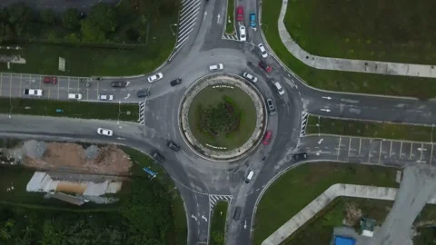 Traffic slow moving roundabout intersection peak hours in Elmina, Selangor Stock Footage 231499085