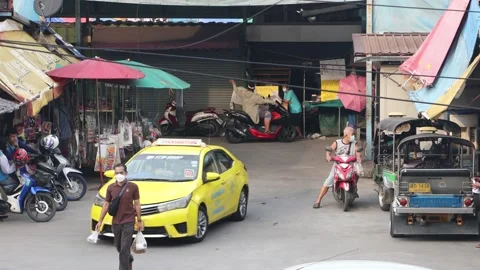 Traffic at a small intersection next to the market at dusk Stock Footage 220198938