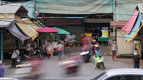 Traffic at a small intersection next to the market at dusk, time lapse Stock Footage 221752855