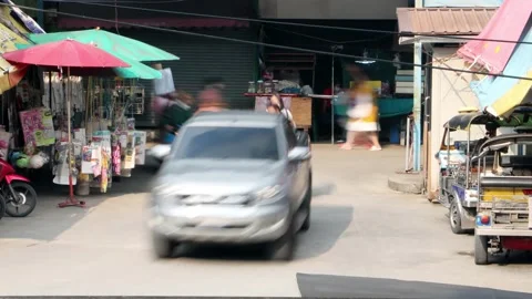 A traffic at a small intersection next to the market, time lapse Stock Footage 233953390