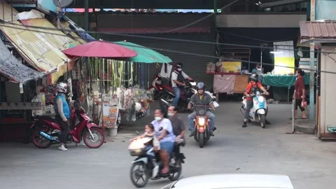 Traffic at a small intersection next to the market at dusk Stock Footage 244933018