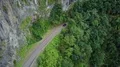 Traffic small mountain street aerial top view between mountain scarp face canyon 4k or 4k+ Resolution