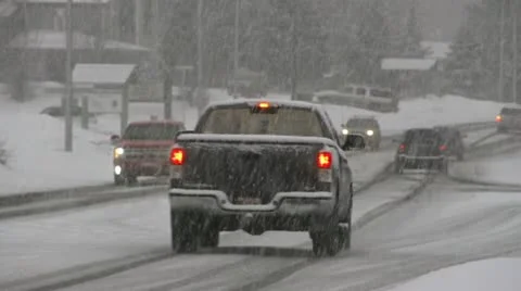Traffic in Snowy Intersection - Winter Driving Homer, AK Stock Footage 21431130