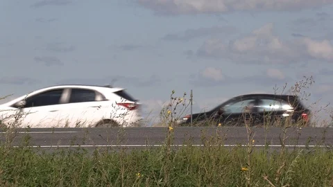 Traffic speeding by camera low angle by highway Stock Footage 115074451