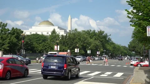 Traffic on standby while people crossing a crosswalk in Washington, DC Stock Footage