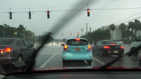 Traffic Stopped at Red Light at Intersection in Boca Raton, Florida in Rain Stock Footage 284176379