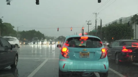 Traffic Stopped at Red Light at Intersection in Boca Raton, Florida in Rain Stock Footage 284176399