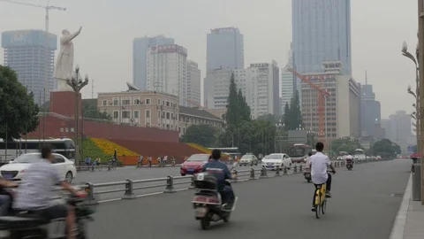 Traffic on street and Mao statue,Chengdu,Sichuan,China Stock Footage