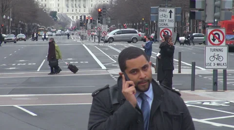 Traffic street car pass people talk mobile phone Washington DC cloudy day road  Stock Footage