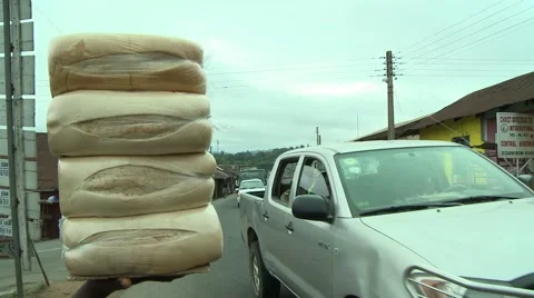 TRAFFIC ON STREET- STACK OF BREAD IN FOREGROUND Stock Footage 59735239