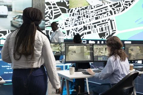 Traffic supervisor coordinating urban mobility through digital systems at desk Stock Photos