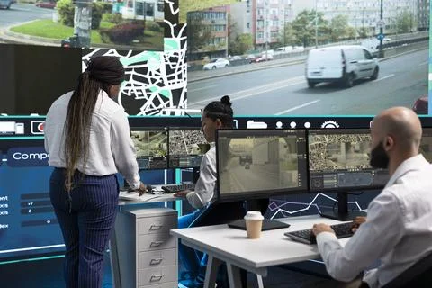 Traffic supervisors analyzing vehicle patterns across city routes Stock Photos