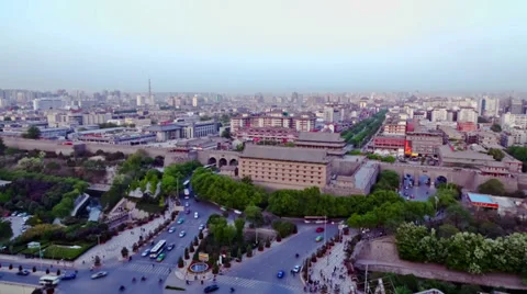 Traffic surrounds gate of Xi'an city wall and skyline of city when day to night Stock Footage 36426332