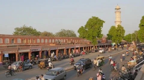 Traffic through bazaar and Ishwar Lat Tower,Jaipur,India Stock Footage 66729671