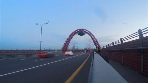 Traffic through cable-stayed bridge in evening timelapse Vidéo 79813718
