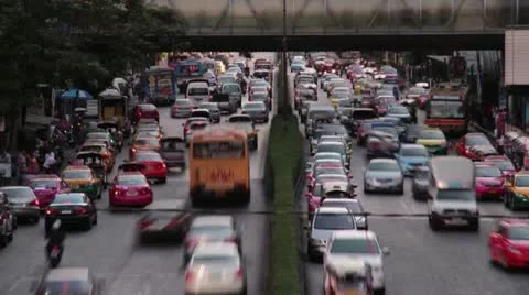 TRAFFIC TIME LAPSE:  Telephoto two lane road with cars, buses and pedestrians Stock Footage