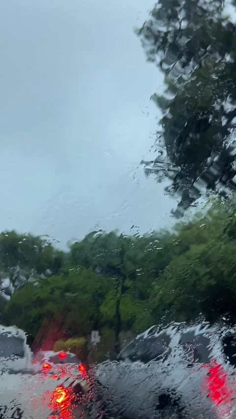 Traffic under the rain hitting the windshield Stock Footage 281054053