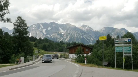 Traffic with the Upper Austria Mountains of the Styria region in the distance Stock Footage 113834200
