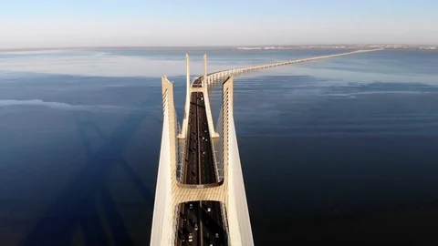 Traffic on Vasco da Gama bridge over the Tagus at sunset in Lisbon, Portugal Stock Footage 96939877