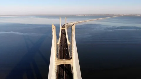 Traffic on Vasco da Gama bridge over the Tagus at sunset in Lisbon, Portugal Stock Footage 96940715