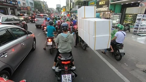 Traffic in Vietnam HCMC hundreds bikes first person view Video stock 143956053