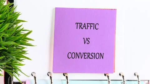 Traffic vs Conversion concept written on a purple sticky note on a spiral not Stock Photos