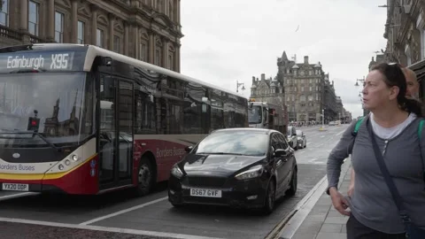 Traffic waiting at lights on North Bridge in Edinburgh Stock Footage 345175308