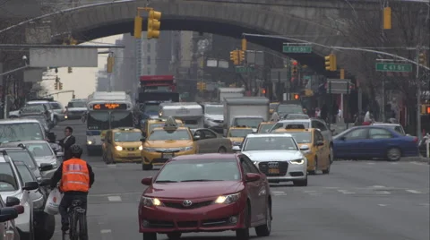 Traffic waiting at a traffic light under the Ed Koch Queensboro Bridge on 1st Stock Footage 51301461