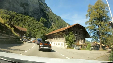 Traffic waiting for train to pass the road, Switzerland Alps village - 4K Stock Footage 270433389