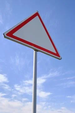 Traffic warning sign background clouds and blue sky. Stock Photos