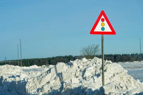 Traffic Warning Sign in Front of Massive Snowbanks After Winter Storm Elli Stock Photos