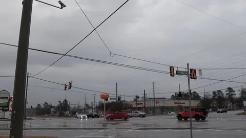 Traffic at a way intersection in rainy conditions and traffic lights Walgreen Stock Footage 148959160
